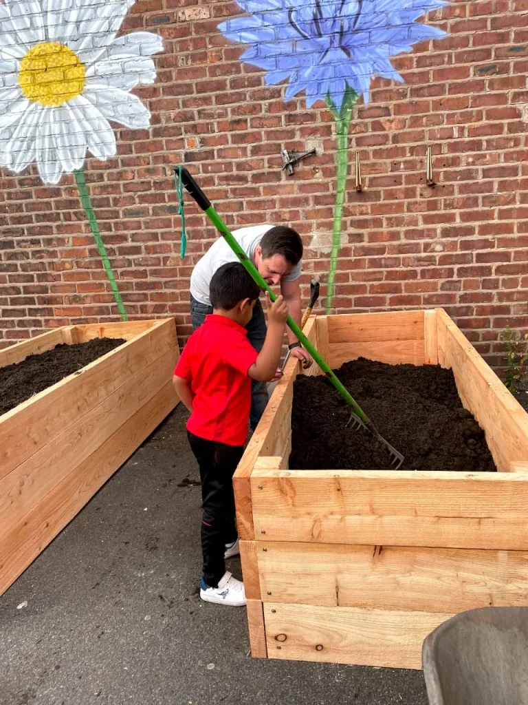 Community members tending raised garden beds