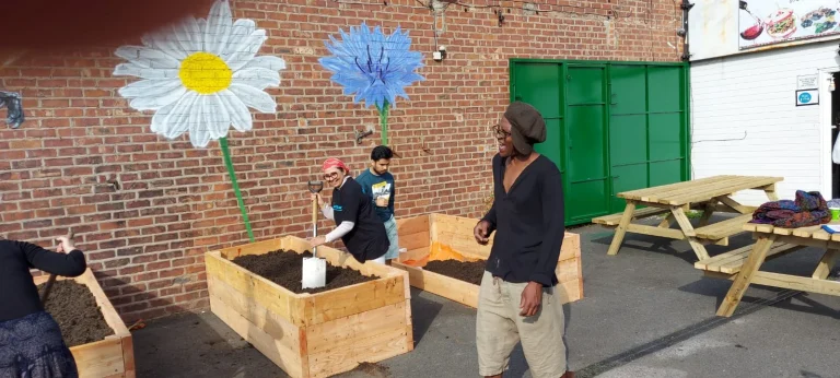 Community members tending raised garden beds
